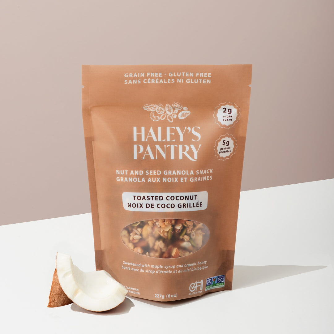 Haley's Pantry toasted coconut nut and seed granola snack package on a white surface with a beige background